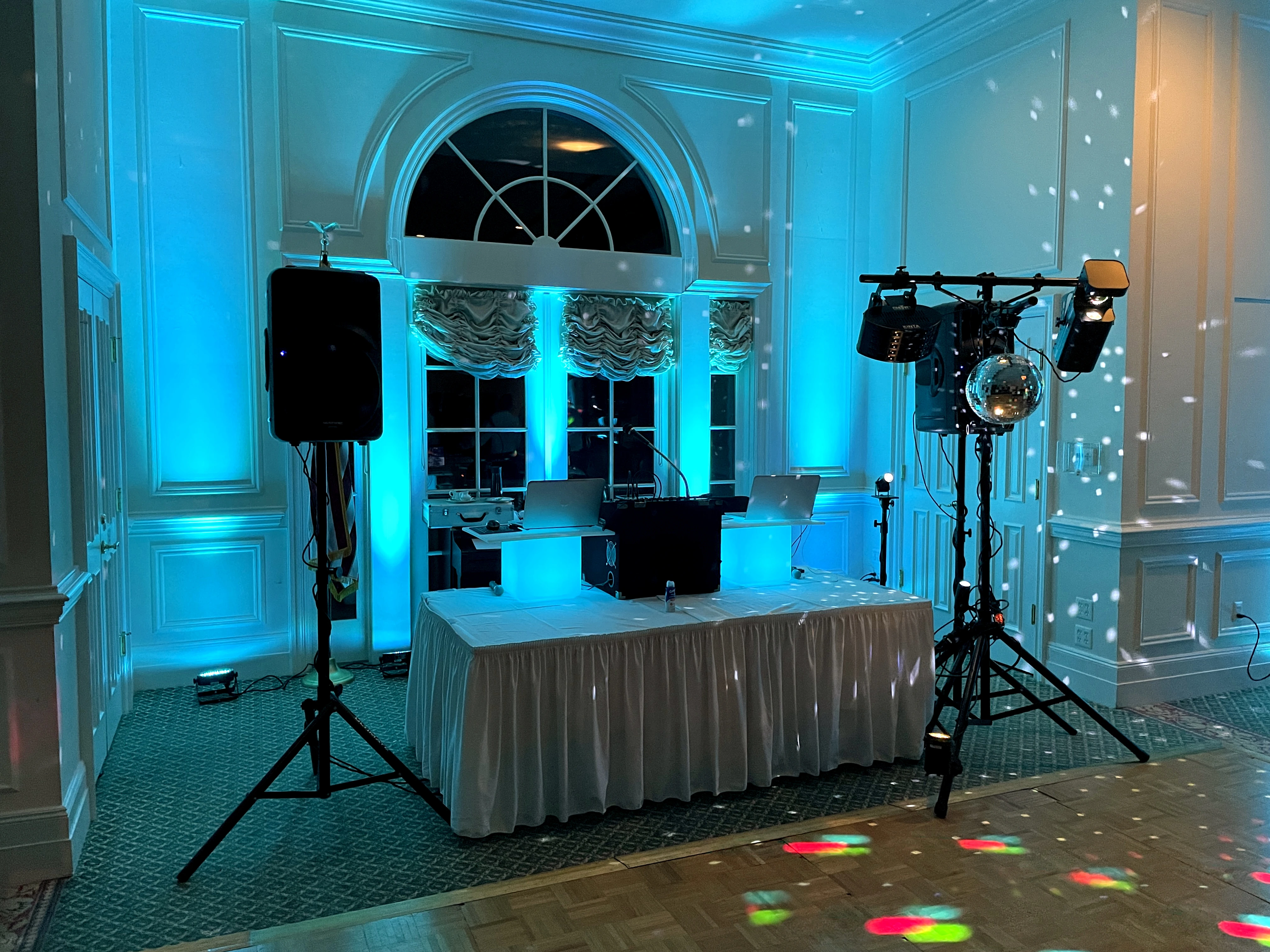Detroit event DJ lighting setup with blue uplighting and professional sound equipment