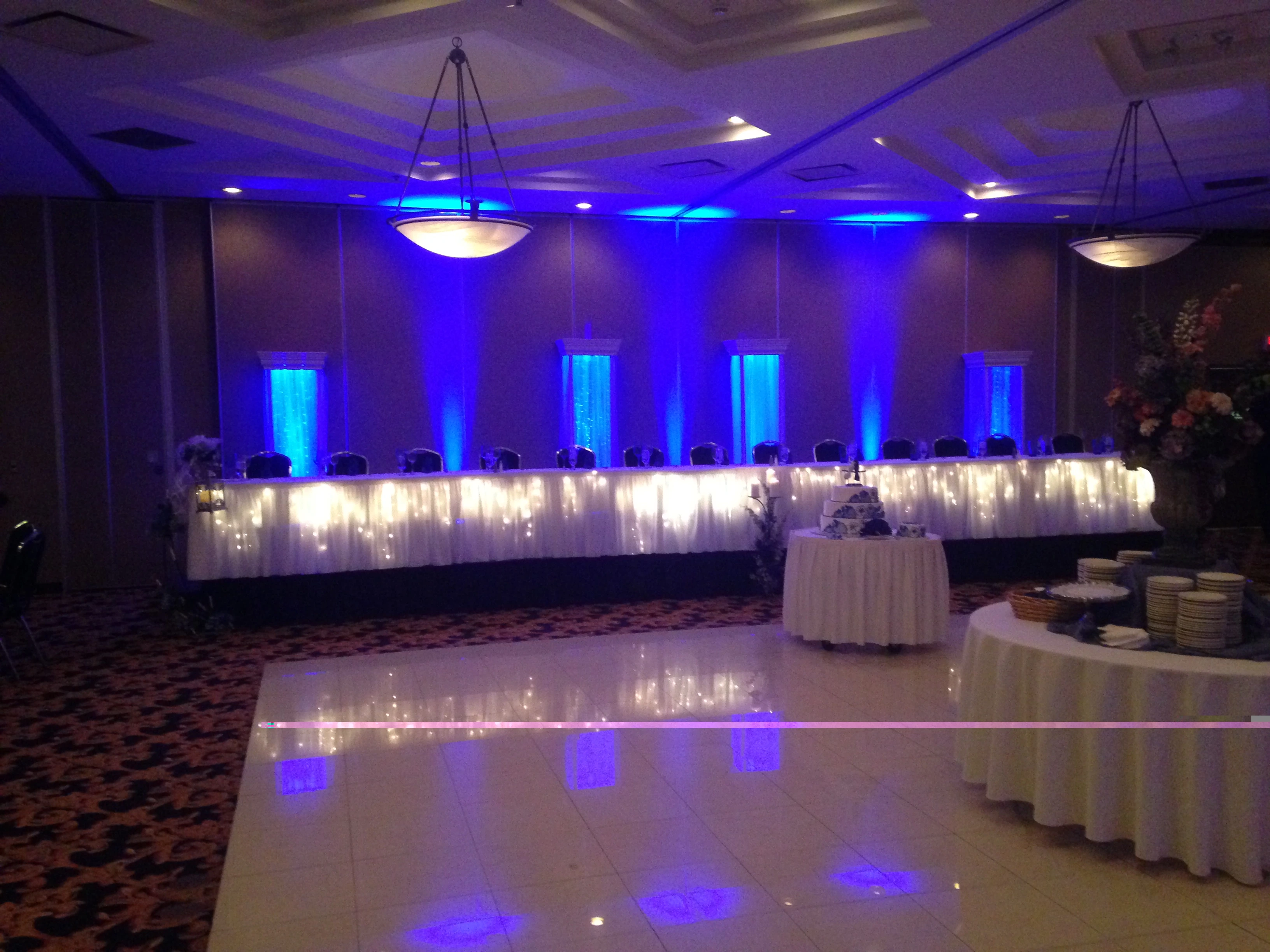 Elegant wedding head table with blue uplighting at a Detroit reception